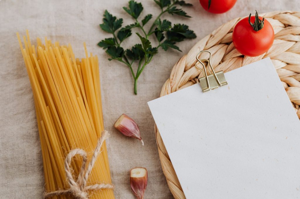 Crafting Captivating Headlines: Your awesome post title goes here Uncooked spaghetti with tomatoes, garlic, and parsley on a rustic setup.