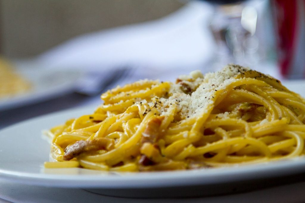 The Art of Drawing Readers In: Your attractive post title goes here Close-up of spaghetti carbonara topped with grated Parmesan cheese on a plate, perfect for Italian cuisine lovers.